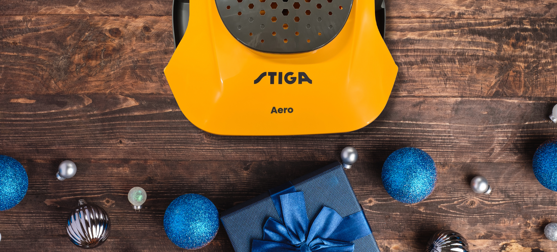 christmas baubles on wooden floor with stiga lawnmower 