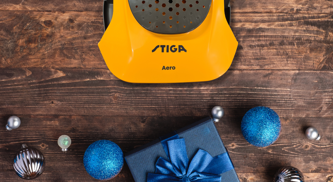 christmas baubles on wooden floor with stiga lawnmower 