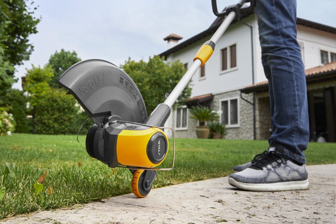 Cutting head of lawn trimmer close to an edge.