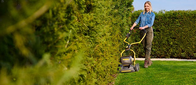 women using a lawn mower