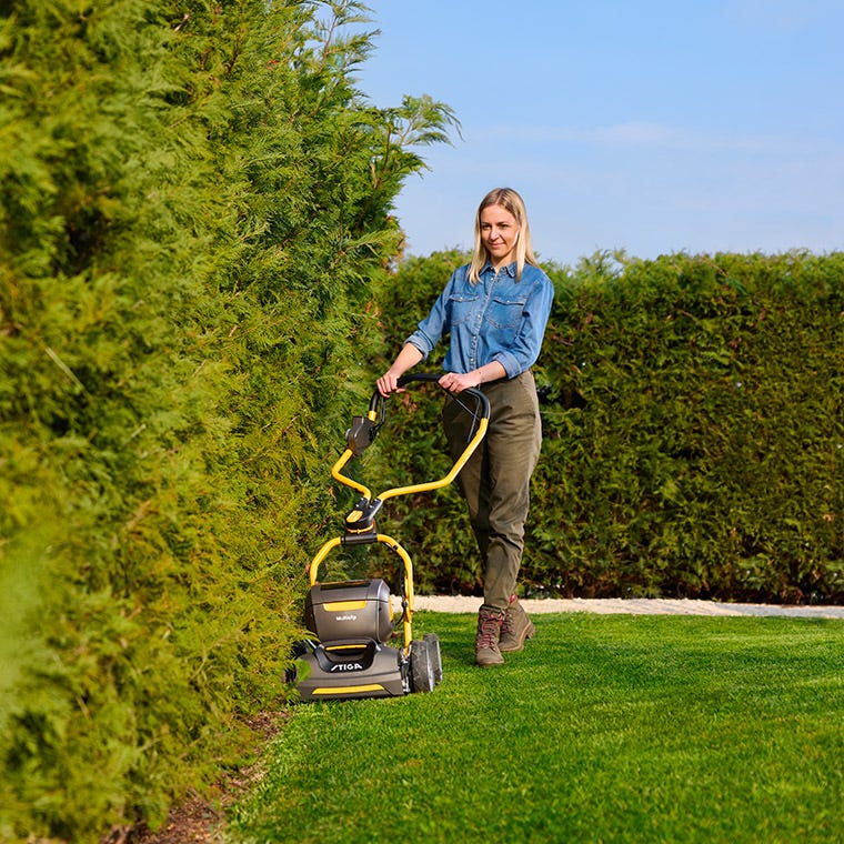 women using a lawn mower