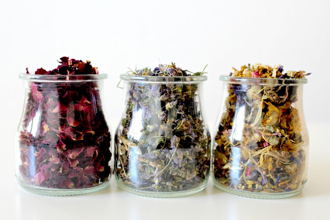 dried flowers in three glass jars