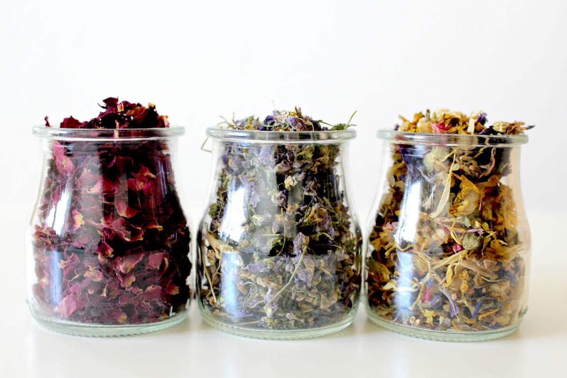 dried flowers in three glass jars 