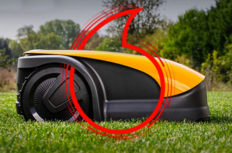 Side view of the autonomous robot mower, with the Vodafone logo on it